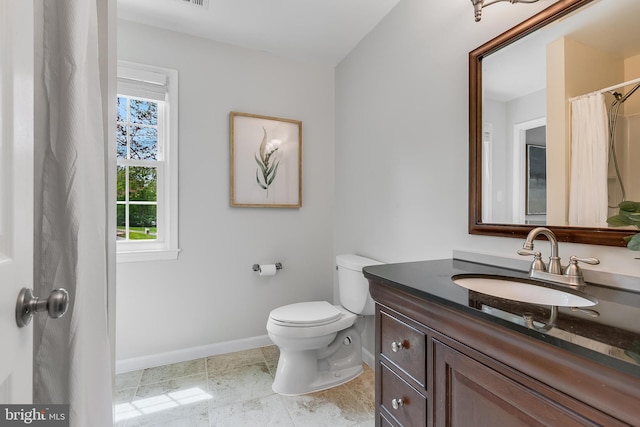 full bath featuring baseboards, toilet, and vanity