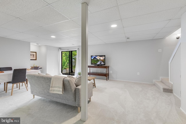 living room with light colored carpet, a drop ceiling, recessed lighting, and stairway