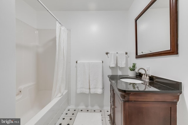 bathroom featuring shower / tub combo, vanity, and baseboards