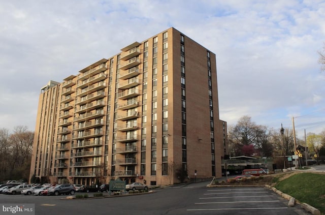 view of property featuring uncovered parking