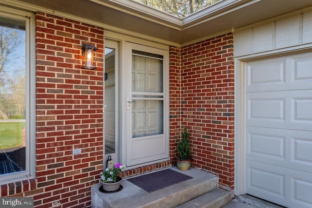 entrance to property featuring brick siding