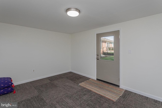 carpeted spare room with baseboards
