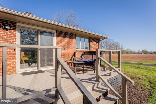 wooden terrace with a yard