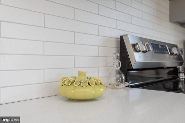 details featuring light countertops and stainless steel range with electric cooktop