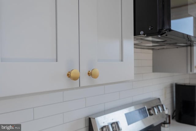 interior details featuring range and backsplash
