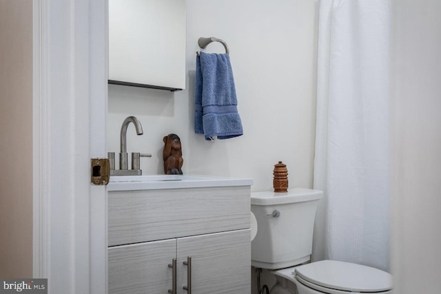 bathroom featuring toilet and vanity