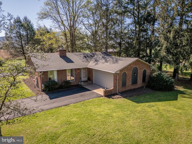 ranch-style home featuring an attached garage, a front lawn, aphalt driveway, brick siding, and a shingled roof