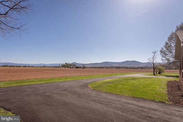 view of street with a rural view and a mountain view