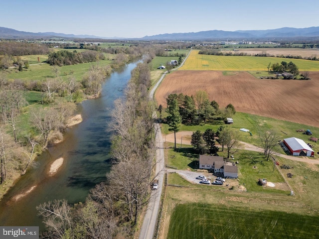 drone / aerial view featuring a rural view and a water and mountain view