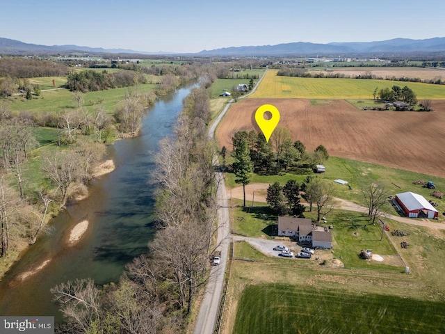 drone / aerial view featuring a rural view and a water and mountain view