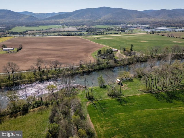 aerial view with a water and mountain view and a rural view