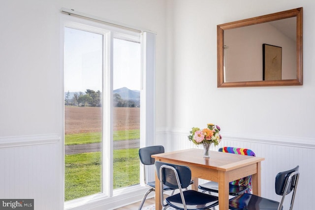 dining area with plenty of natural light and wainscoting