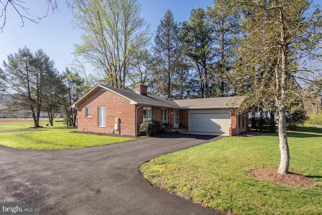 single story home featuring aphalt driveway, a garage, a front yard, and brick siding