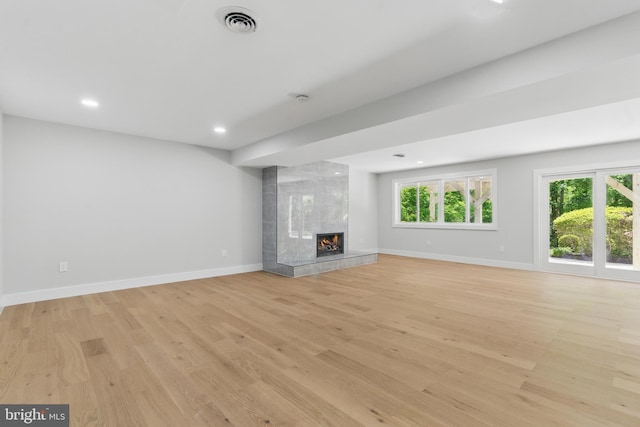 4838 Randolph Dr, Annandale, VA 22003 - unfurnished living room featuring baseboards, a high end fireplace, light wood-style flooring, and plenty of natural light