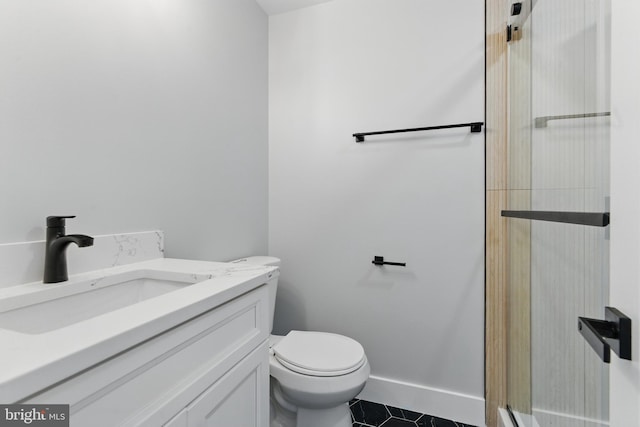 4838 Randolph Dr, Annandale, VA 22003 - bathroom featuring a shower with shower door, vanity, toilet, tile patterned floors, and baseboards