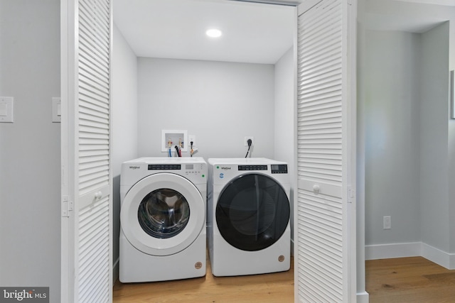 4838 Randolph Dr, Annandale, VA 22003 - clothes washing area featuring separate washer and dryer, laundry area, light wood-style flooring, and baseboards