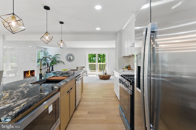 4838 Randolph Dr, Annandale, VA 22003 - kitchen with a high end fireplace, appliances with stainless steel finishes, a sink, light wood-style floors, and recessed lighting