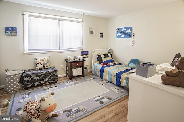bedroom with wood finished floors