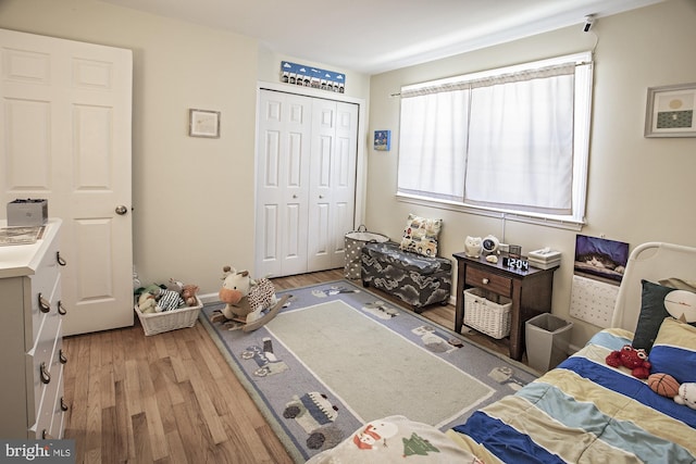 bedroom featuring a closet and light wood finished floors