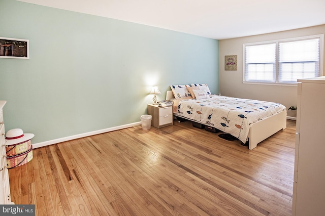 bedroom featuring baseboards and wood finished floors