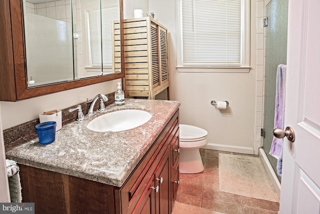 full bathroom featuring vanity, baseboards, tile patterned floors, toilet, and a shower with shower door