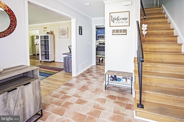interior space featuring tile patterned flooring, visible vents, baseboards, and ornamental molding