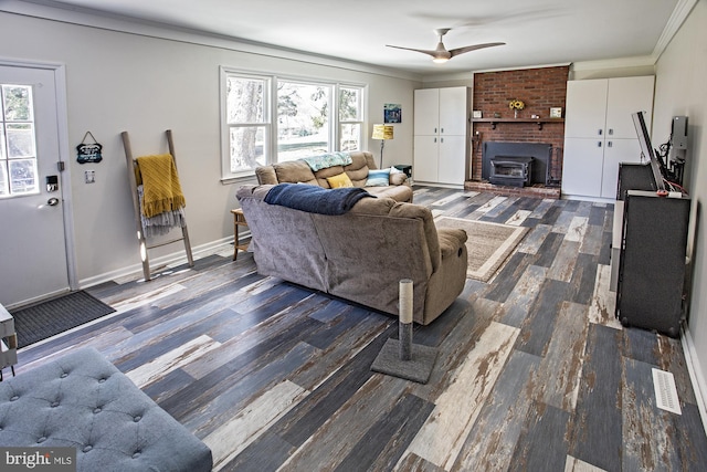 living area with visible vents, dark wood-style flooring, ornamental molding, and plenty of natural light