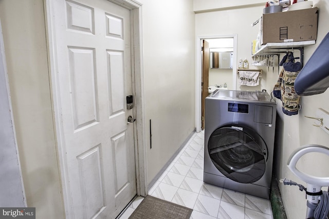 laundry room featuring cabinet space and washer / dryer