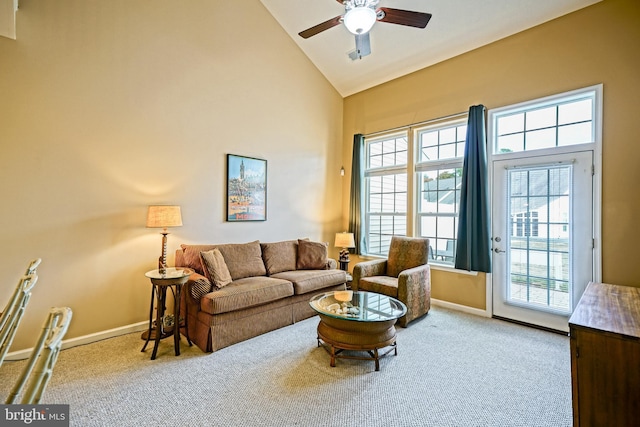 living room with high vaulted ceiling, carpet flooring, baseboards, and ceiling fan