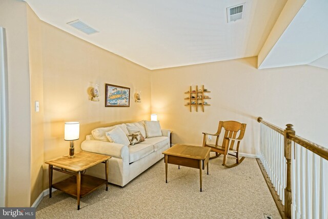 living room featuring baseboards, visible vents, and carpet floors