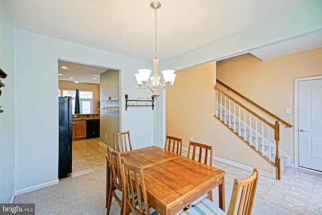 dining area featuring a notable chandelier, baseboards, and stairway