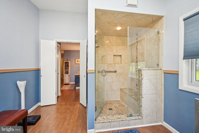 205 S Lehigh Rd, Glassboro, NJ 08028 - bathroom featuring wood finished floors, visible vents, a stall shower, and baseboards
