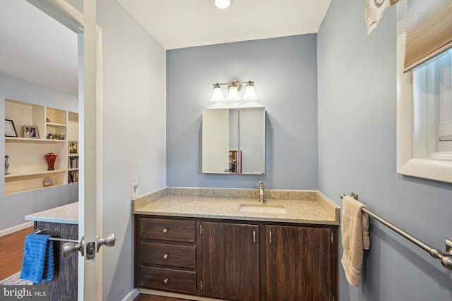 205 S Lehigh Rd, Glassboro, NJ 08028 - bathroom featuring wood finished floors, vanity, and baseboards
