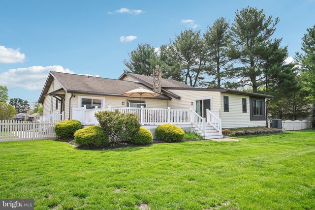 205 S Lehigh Rd, Glassboro, NJ 08028 - rear view of house with a yard, fence, a chimney, and central AC unit