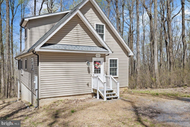 view of front of house with a shingled roof