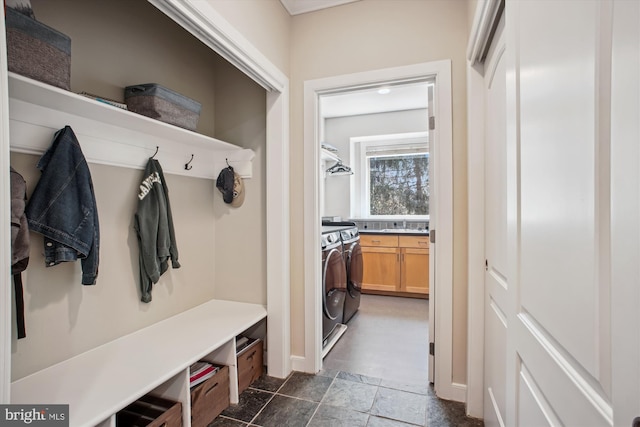 mudroom with stone finish flooring and separate washer and dryer