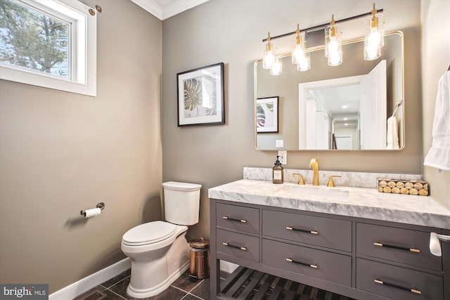 bathroom with toilet, crown molding, tile patterned floors, vanity, and baseboards