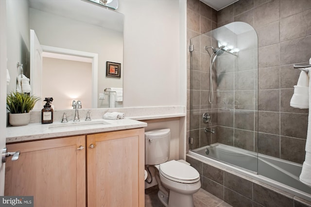 full bath with tiled shower / bath combo, vanity, and toilet