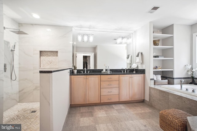 full bathroom with walk in shower, visible vents, and a sink