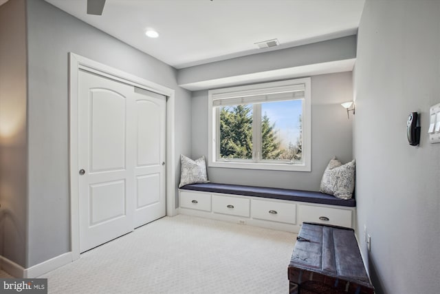 interior space featuring baseboards, visible vents, and carpet