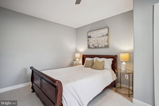 carpeted bedroom featuring ceiling fan and baseboards