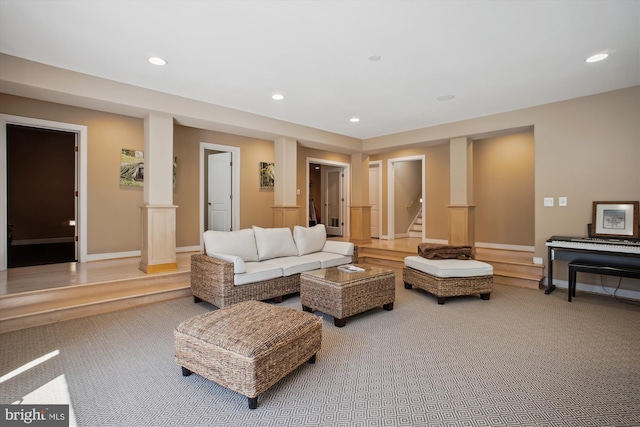 living area with light colored carpet, baseboards, stairs, and recessed lighting
