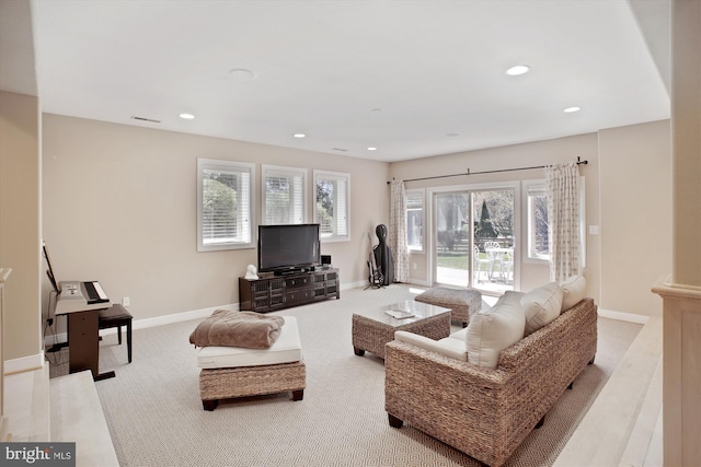carpeted living room featuring recessed lighting, plenty of natural light, visible vents, and baseboards