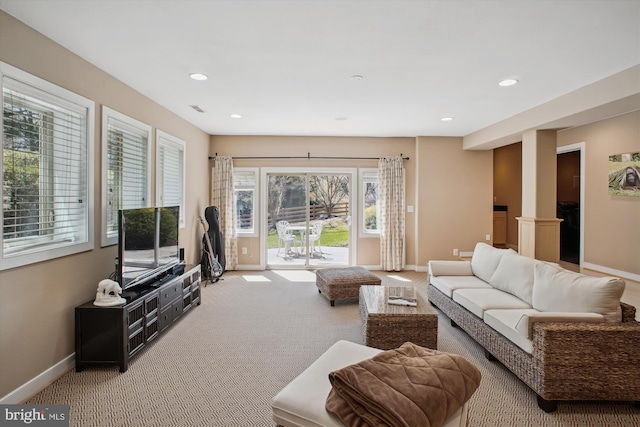living area with visible vents, baseboards, recessed lighting, ornate columns, and carpet floors