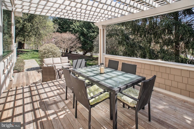 deck featuring outdoor dining space, an outdoor living space, and a pergola