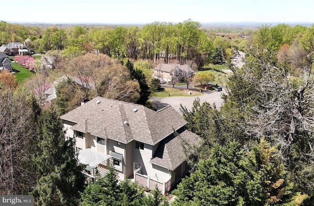 birds eye view of property with a forest view