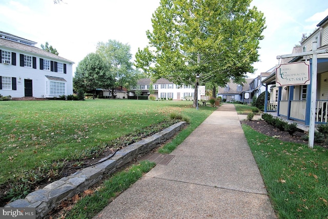 view of community with a yard and a residential view