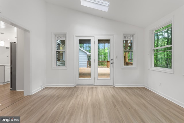 5235 Chalk Point Rd, West River, MD 20778 - doorway to outside featuring light wood finished floors, lofted ceiling, plenty of natural light, a skylight, and baseboards