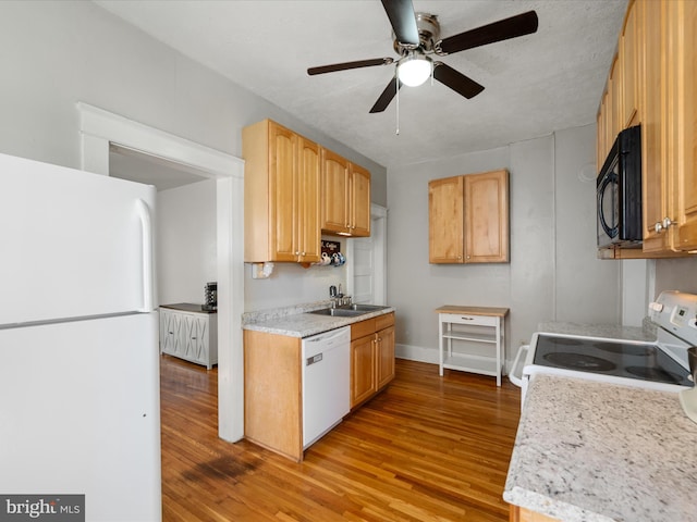 kitchen featuring baseboards, light wood-style floors, a ceiling fan, white appliances, and light countertops