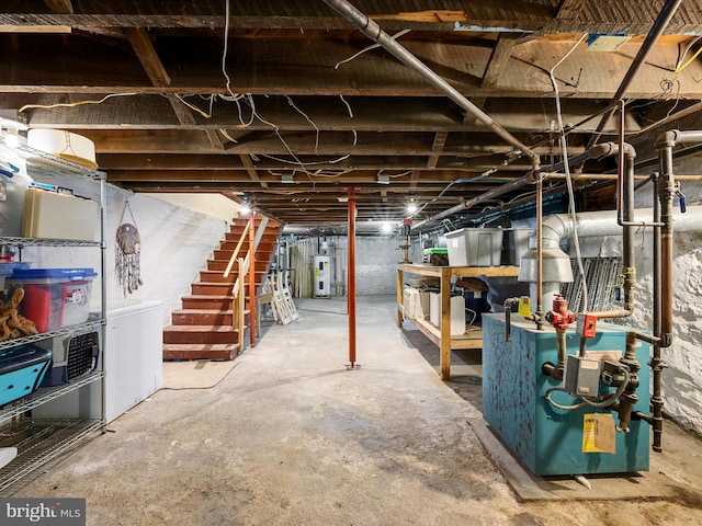 unfinished basement featuring washing machine and dryer, electric water heater, stairs, and a heating unit